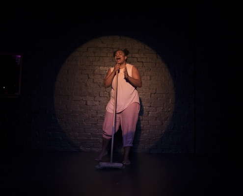 Ghenoa Gela in the spotlight during My Urrwai performance. Image by Daniel Boud.