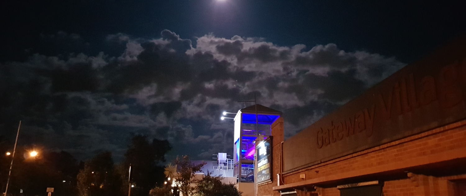 Image of moon over Gateway Village
